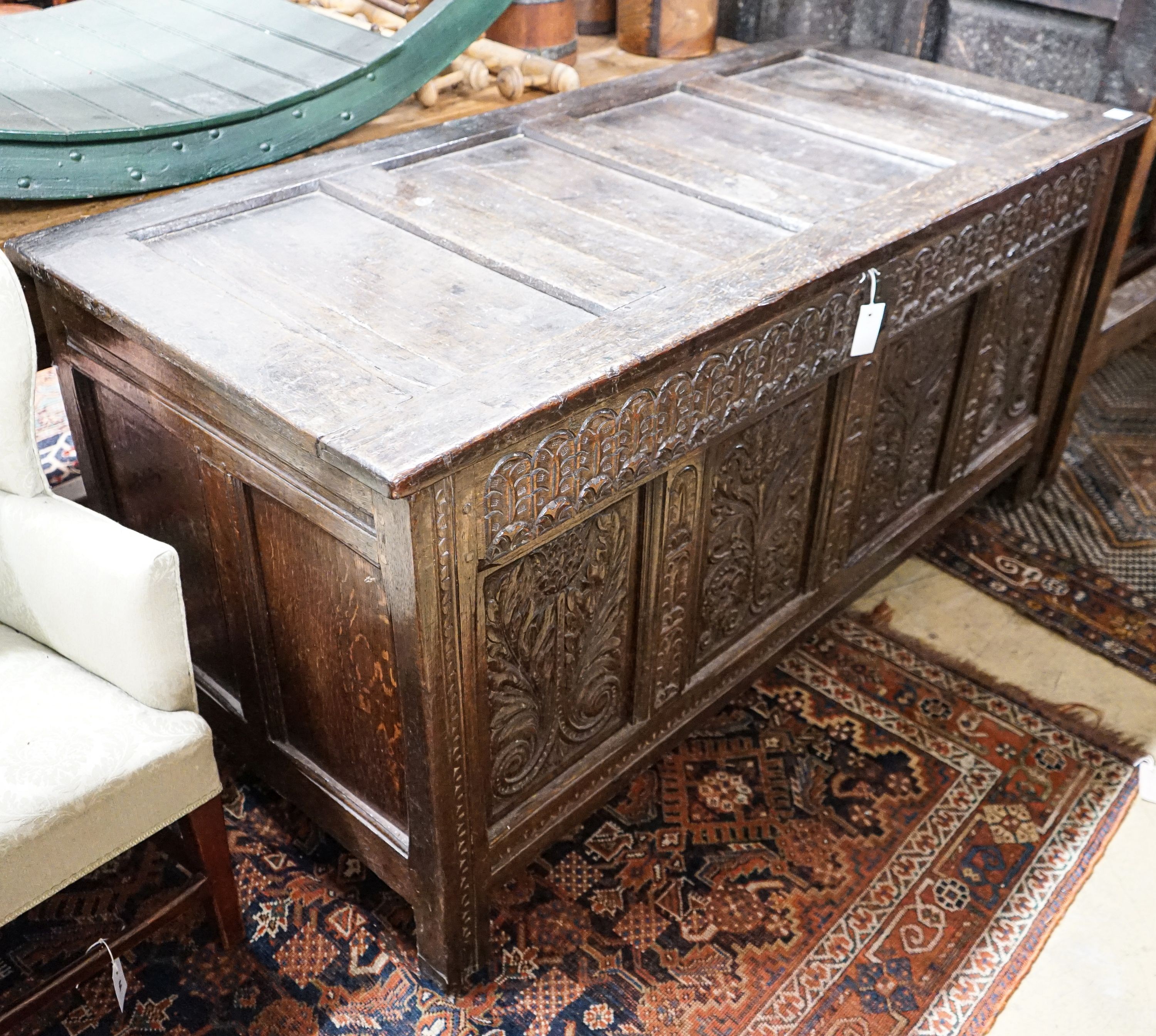 A large 17th century foliate carved oak coffer, length 159cm, depth 72cm, height 76cm